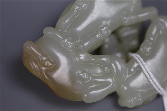 A Chinese pale celadon and russet jade group of three goats, 19th/20th century, 5cm, wood stand